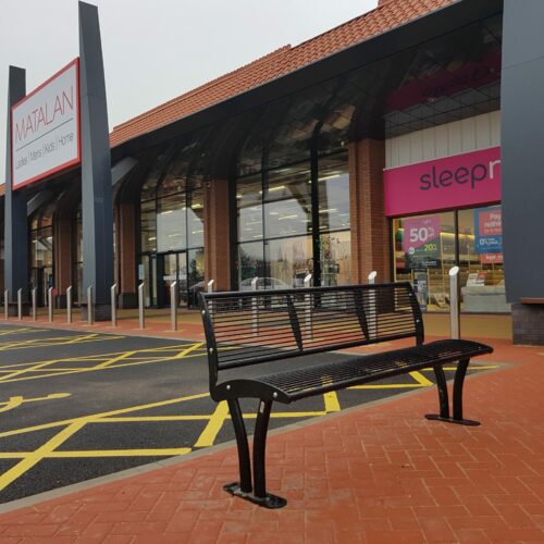 Parkbank Tauri Color 26 Straatbank Tauri Color geplaatst voor een winkelcentrum.